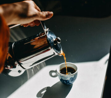 pouring espresso coffee into an espresso cup with a mocha pot stefania pelfini la waziya photography 1